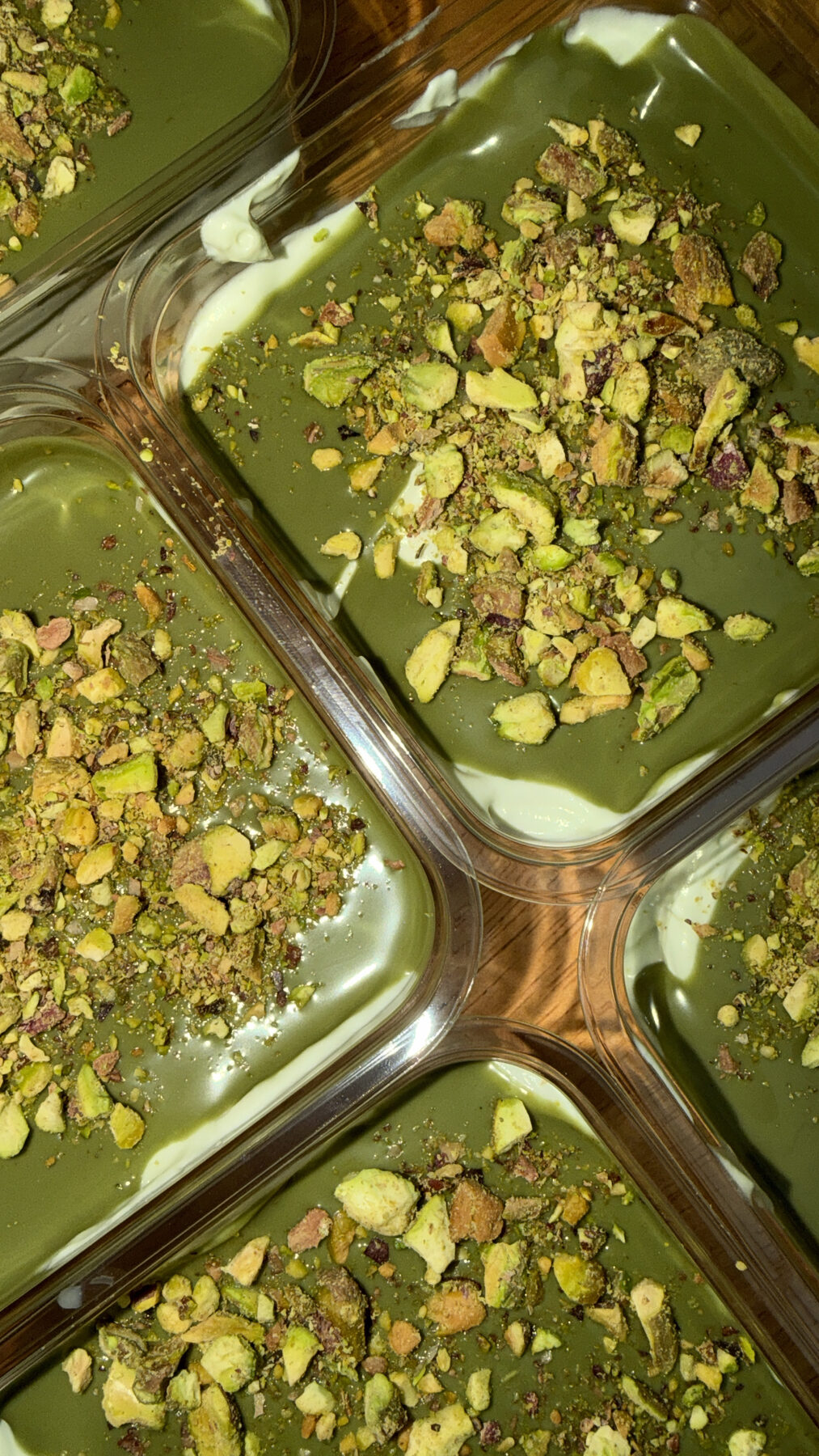 Pistachio dessert cups topped with crushed pistachios on the 249 Bitez dessert table.