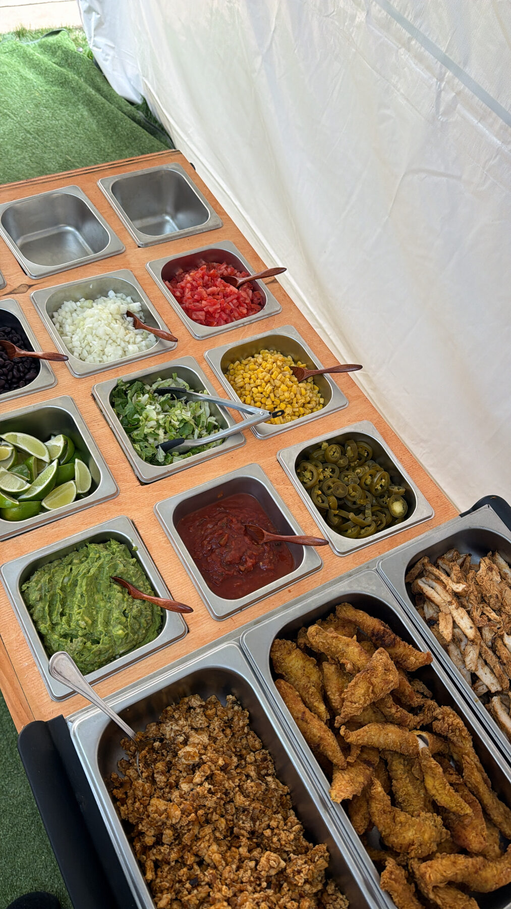 The 249 Bitez taco topping bar — guacamole, salsa, corn, jalapeños, and fresh proteins.