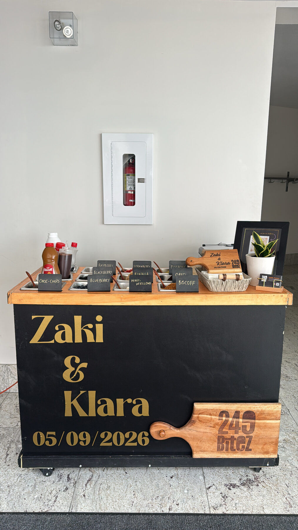 The 249 Bitez waffle cart personalized for a couple's wedding, with chalk-labelled topping stations.