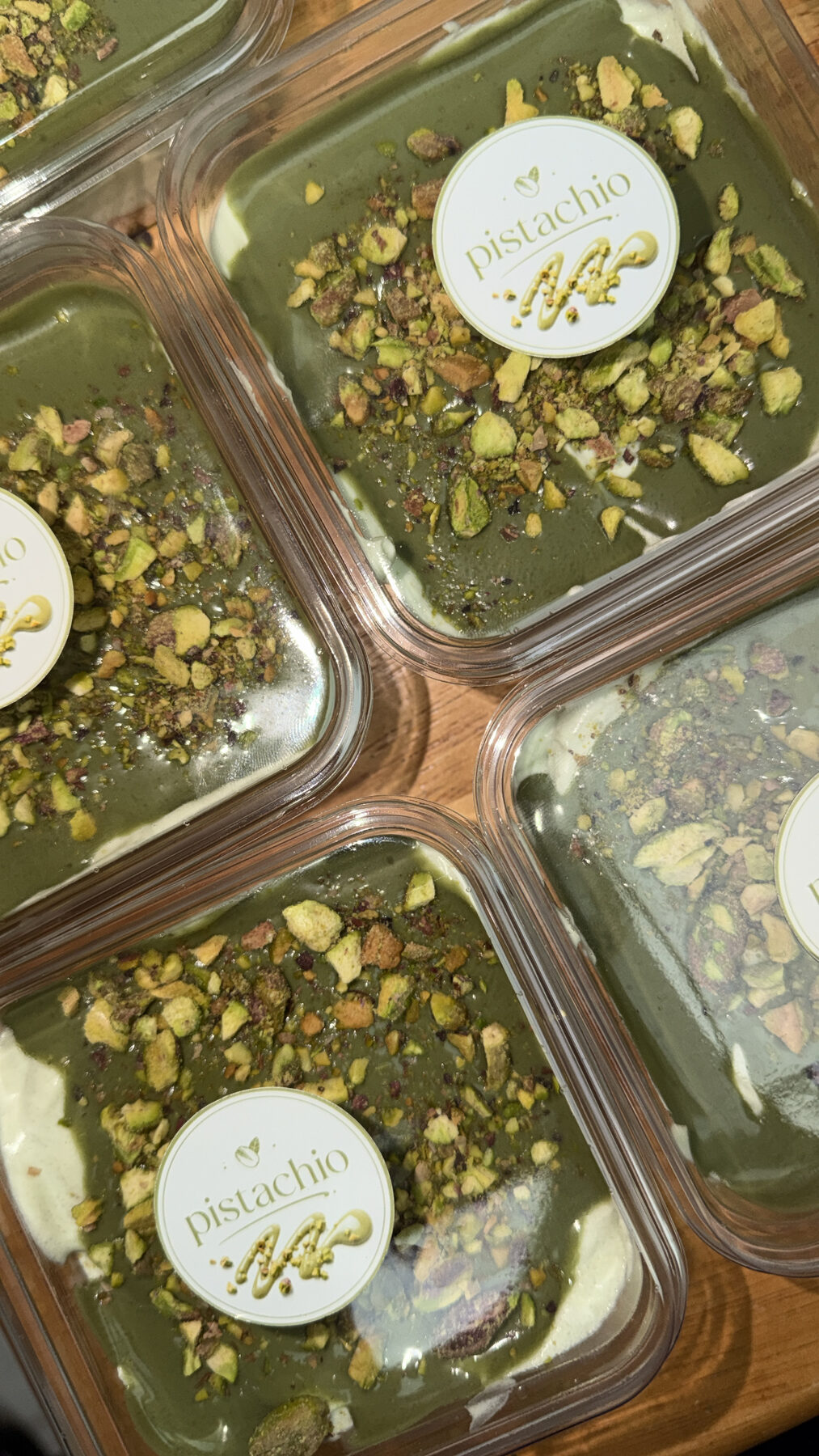 Pistachio cheesecake cups topped with crushed pistachios.