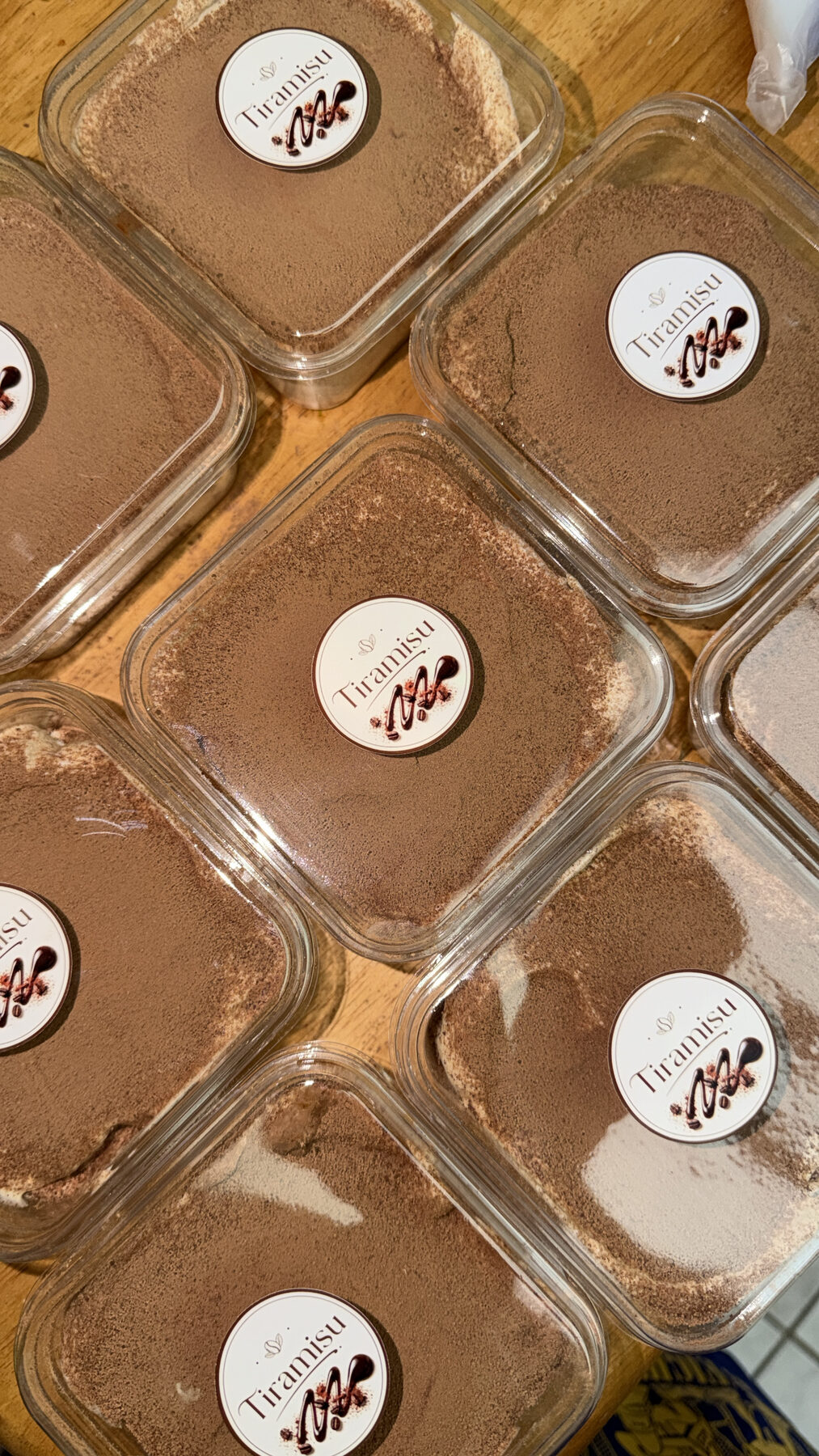 Tiramisu dessert cups dusted with cocoa.