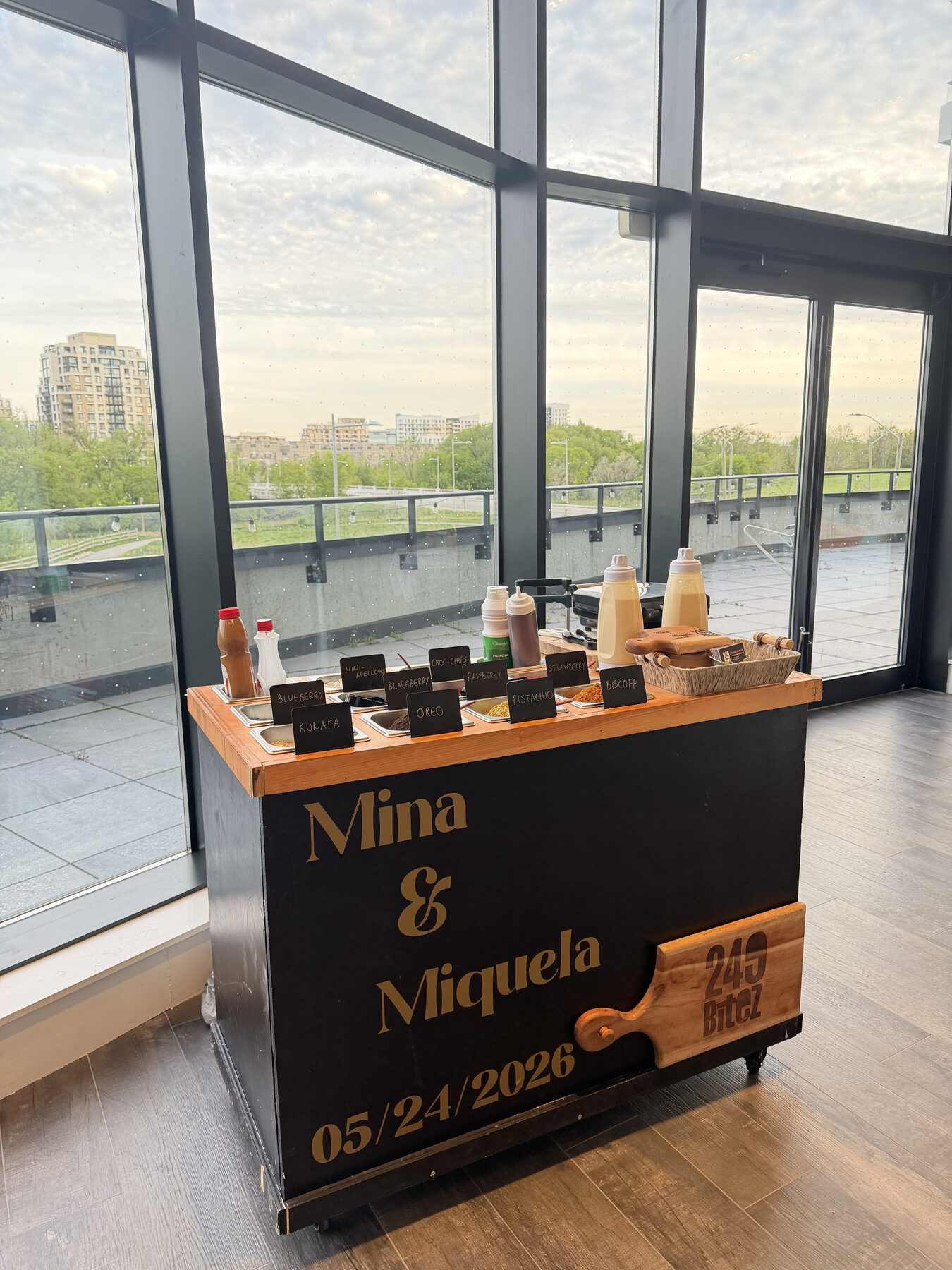 The waffle cart set against floor-to-ceiling windows for Mina & Miquela's day.
