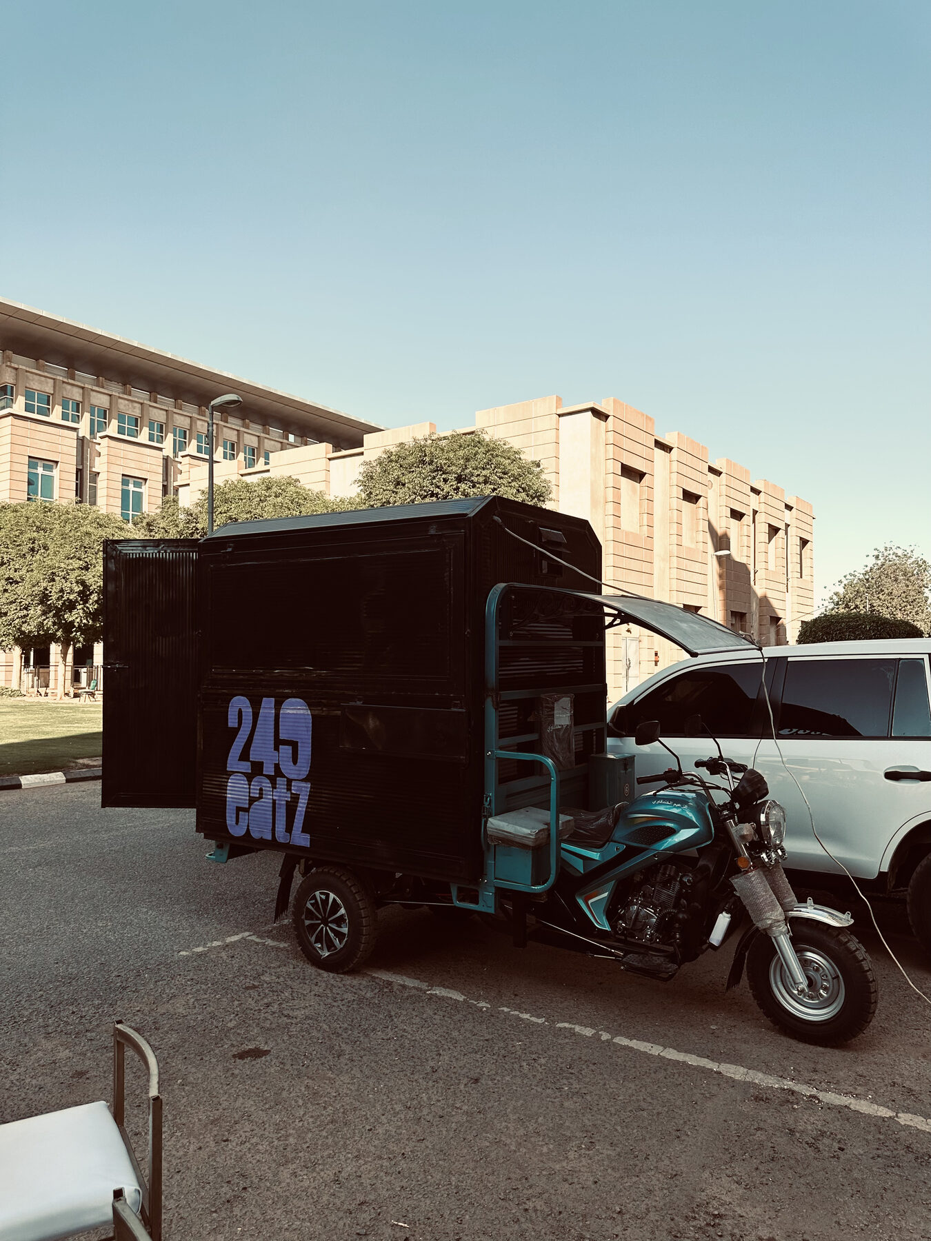 The original black 249 Eatz three-wheeler food truck parked in Khartoum.